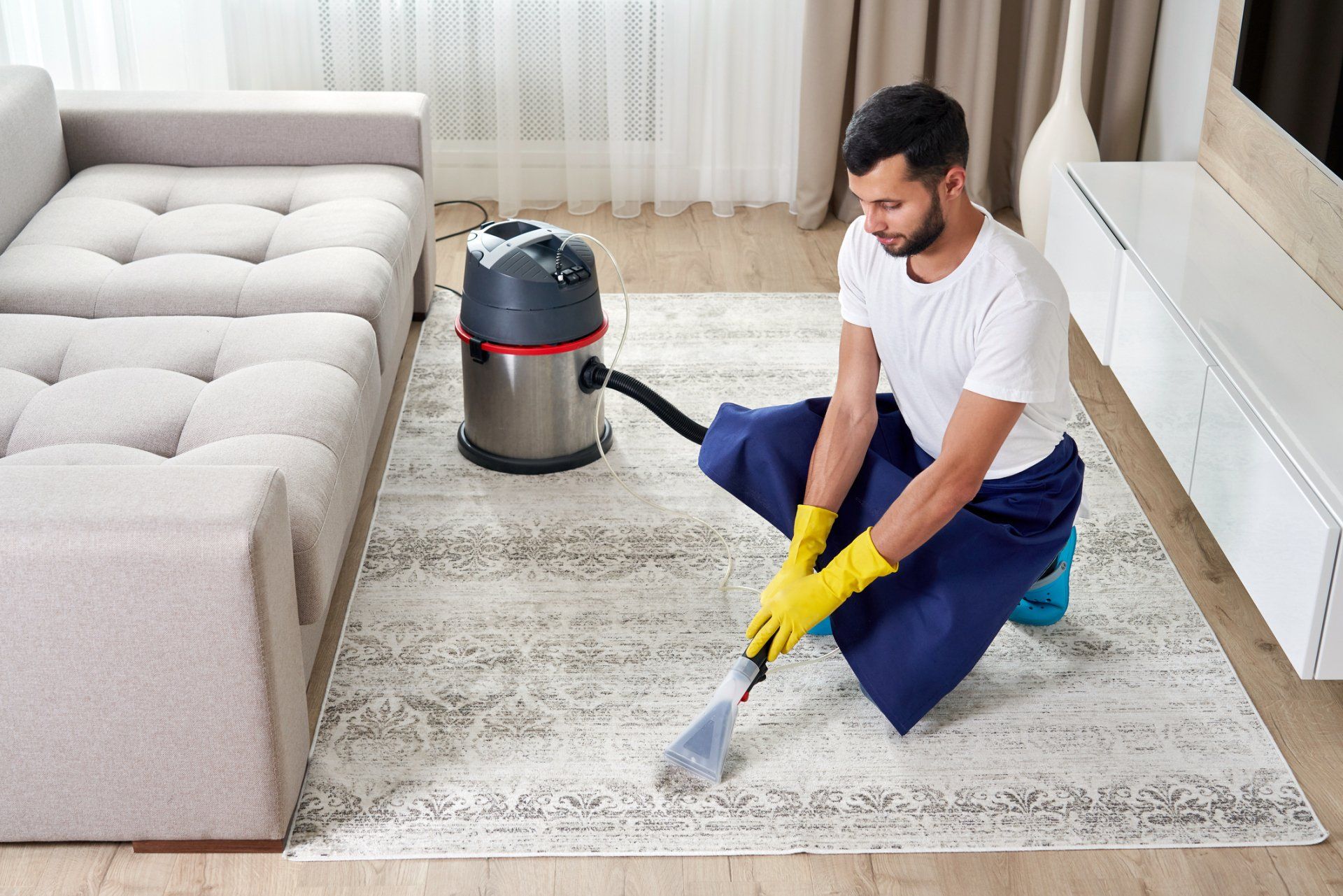 Man Cleaning Carpet In The Living Room — Bryan, OH — Sammons Carpet Care