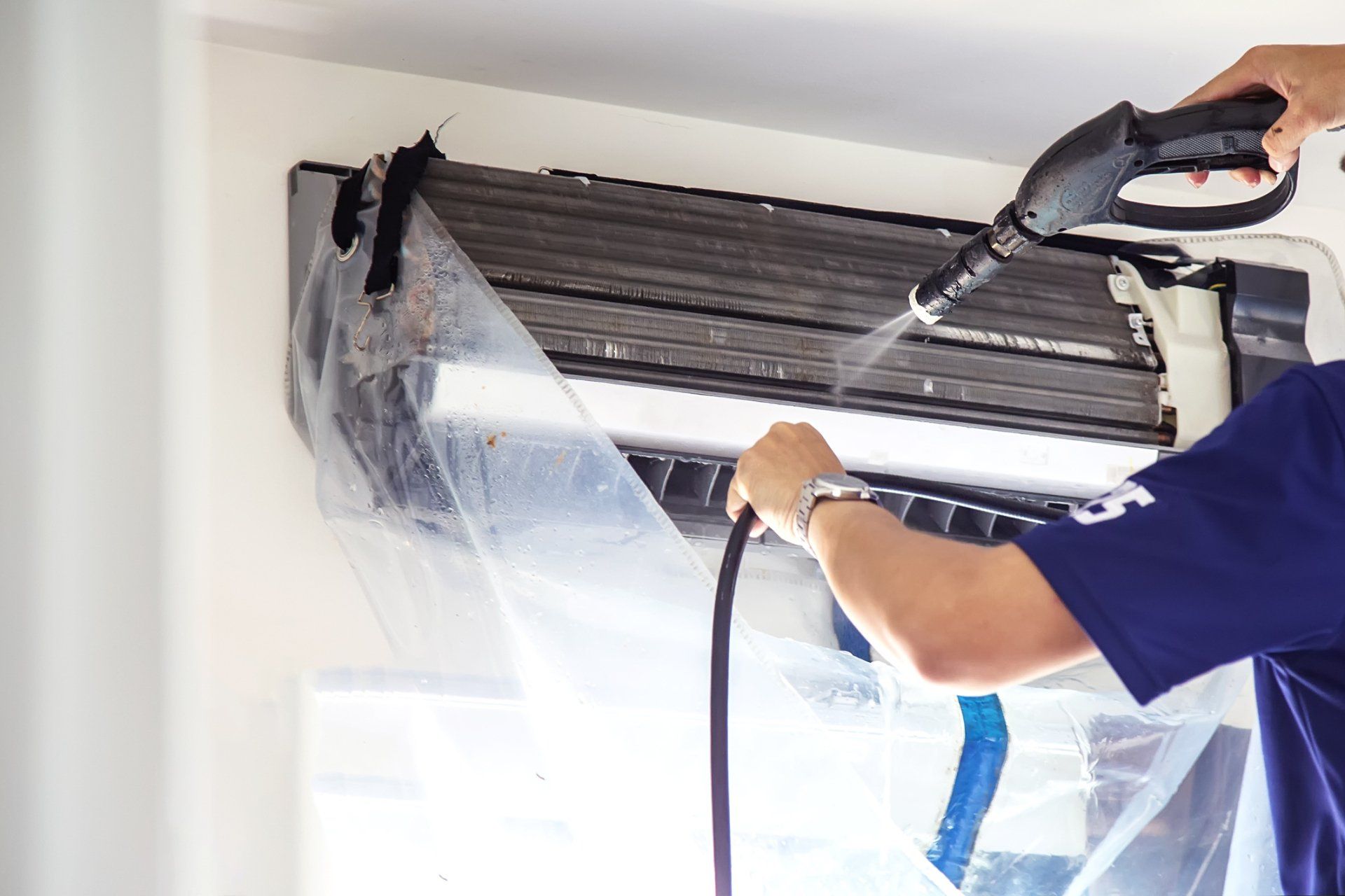 Technician Cleaning The Air Conditioner — Bryan, OH — Sammons Carpet Care