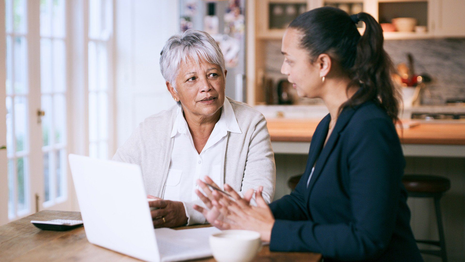Shot of a Senior Woman Using a Laptop During a Meeting with a Consultant at Home — Keysborough Vic — Winn Lawyers