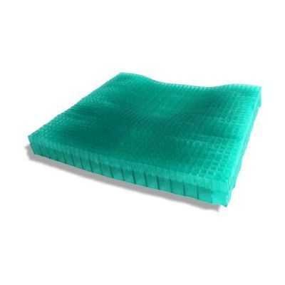 A Green Cushion is Sitting on a White Surface — Coast 2 Coast Disability Support Services in Taree, NSW