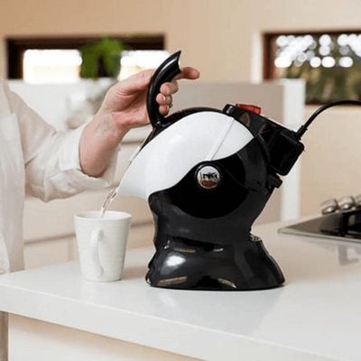A Person is Pouring Water From a Kettle Into a Cup — Coast 2 Coast Disability Support Services in Taree, NSW