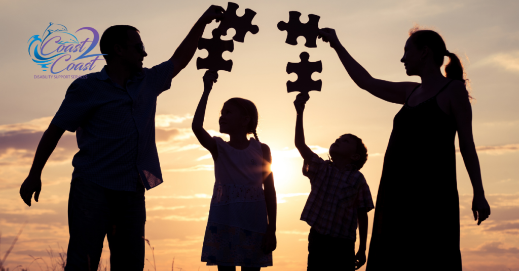 A Family Is Holding up Puzzle Pieces — Coast 2 Coast Disability Support Services in Taree, NSW