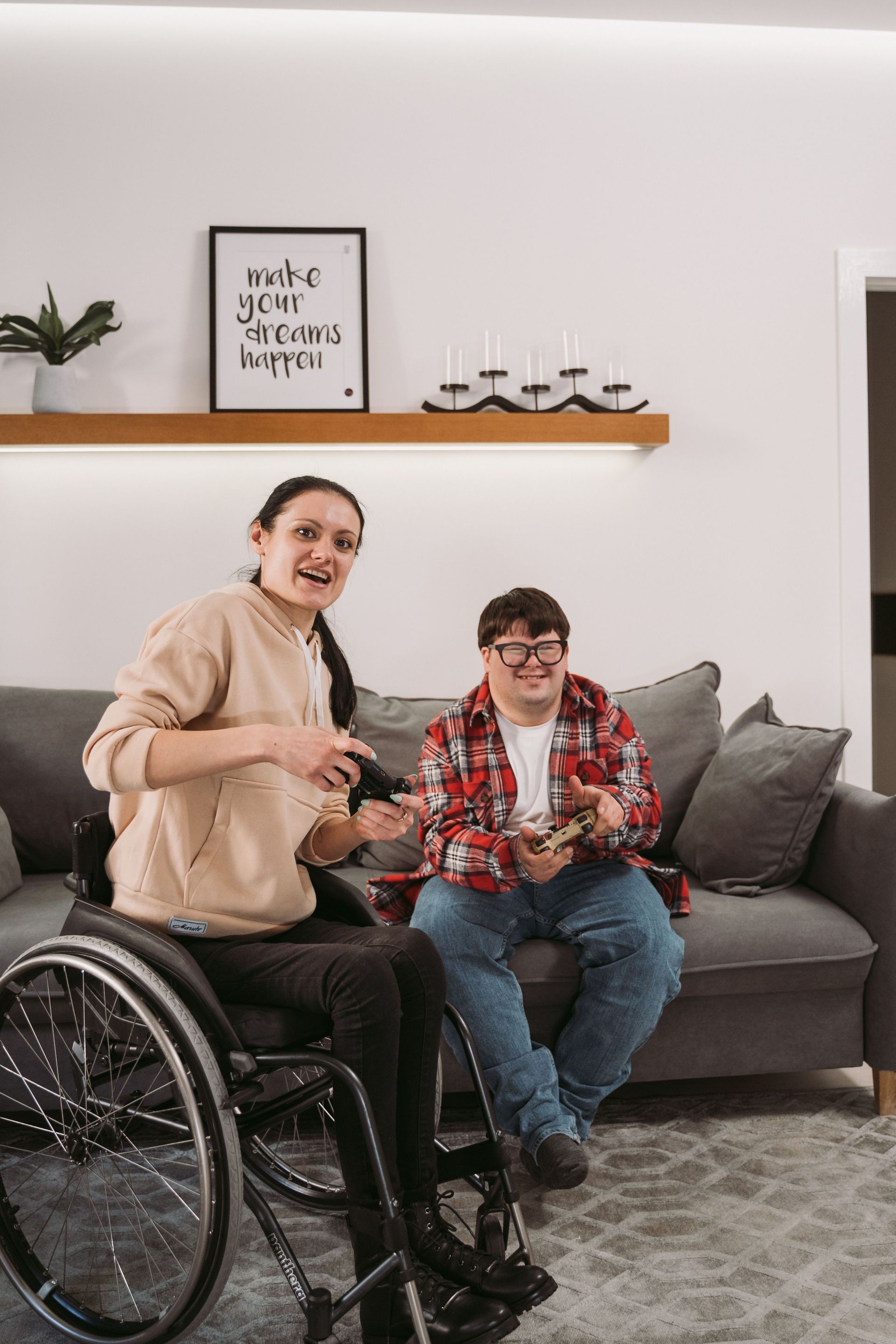 A Woman Is Standing Next to A Boy in A Wheelchair — Coast 2 Coast Disability Support Services in Taree, NSW