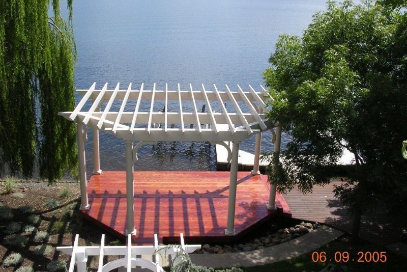 white pergola near the water
