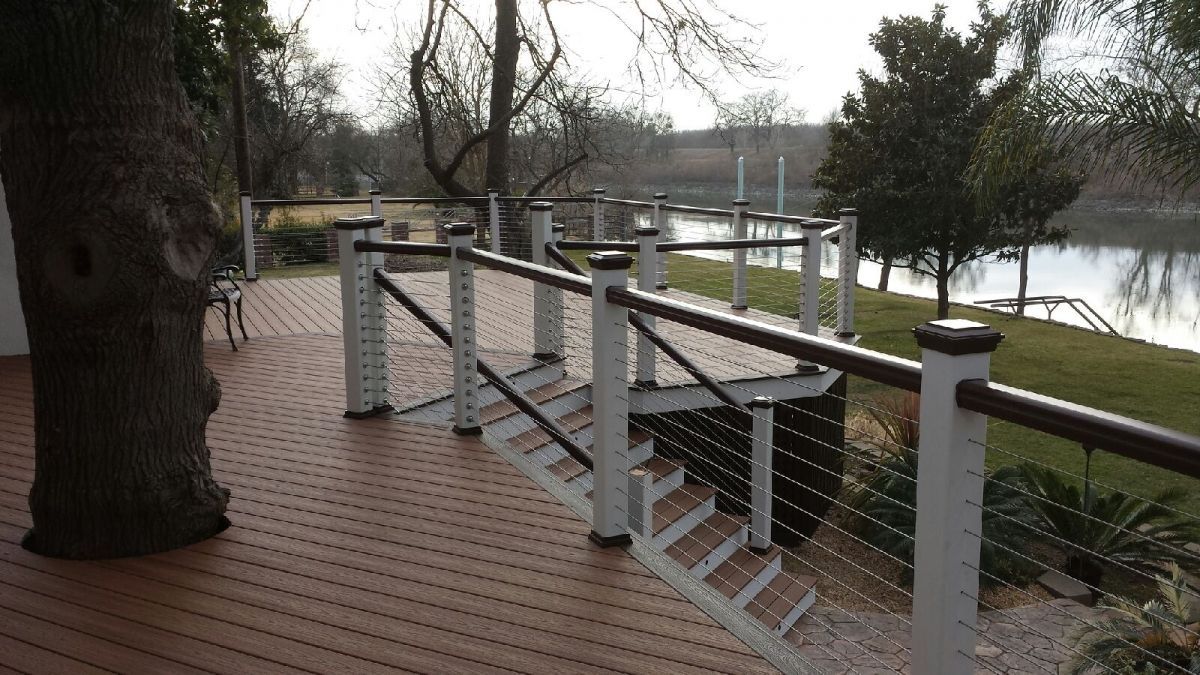elevated wood deck installation with stairs and railing