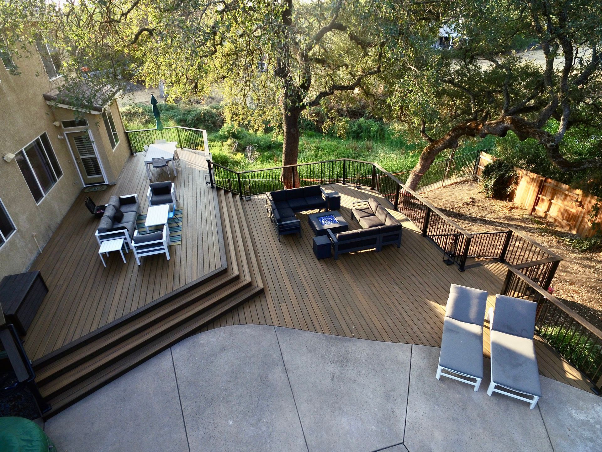 backyard decking installed with  steps leading to another deck area