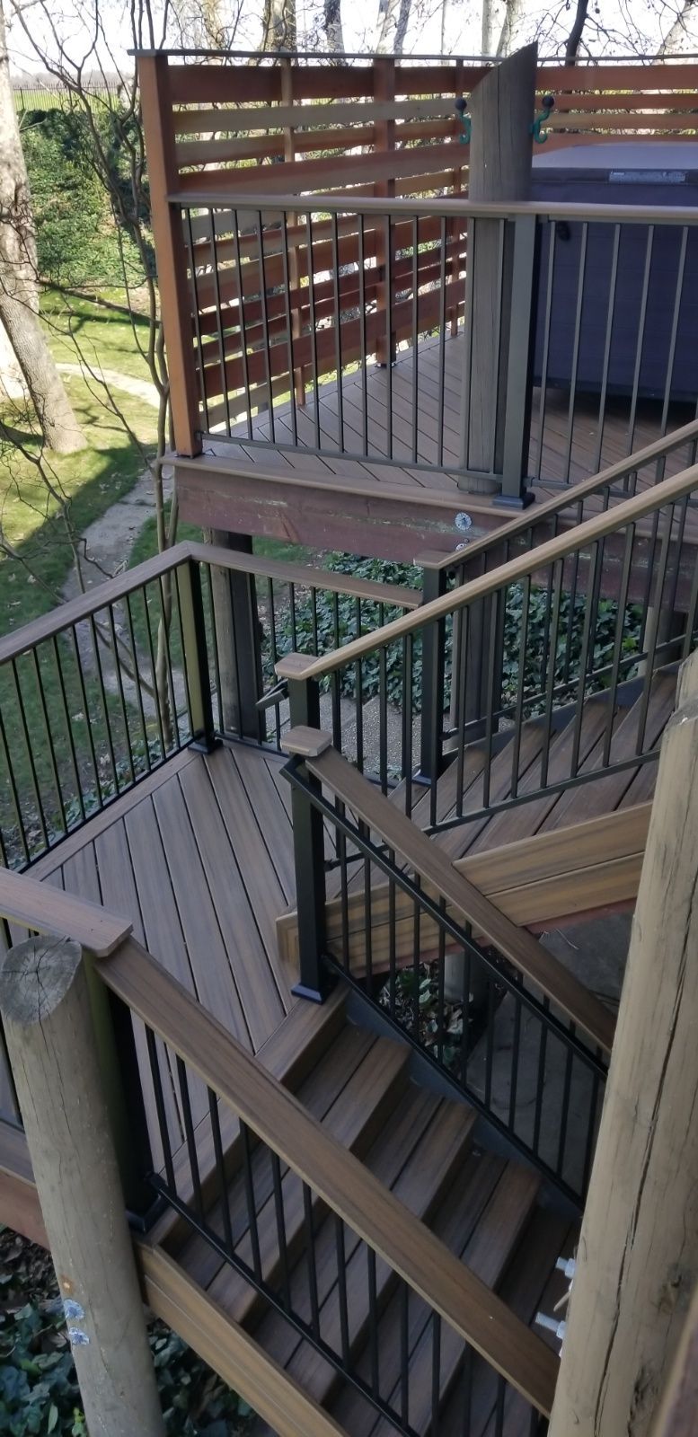black metal railing with light wood accent for handrails
