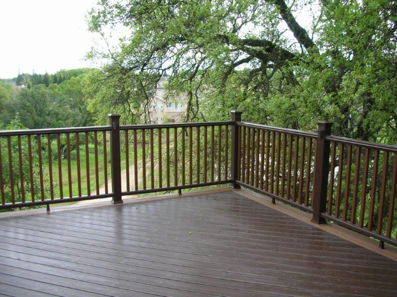 new dark wood railing with slin wood slats