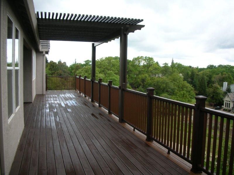 new wood deck railing  with thin wood slats overlooking the countryside