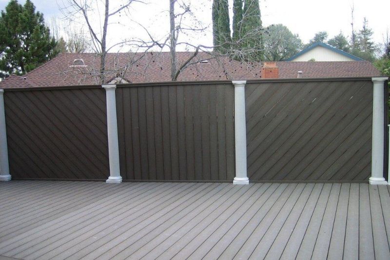 new dark wood fence with white posts