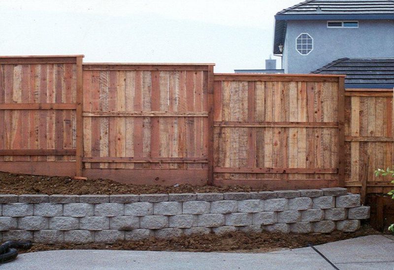 wood fencing built on retaining wall