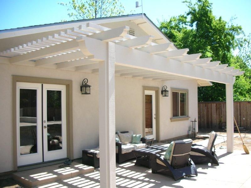 New white painted pergola for back patio space