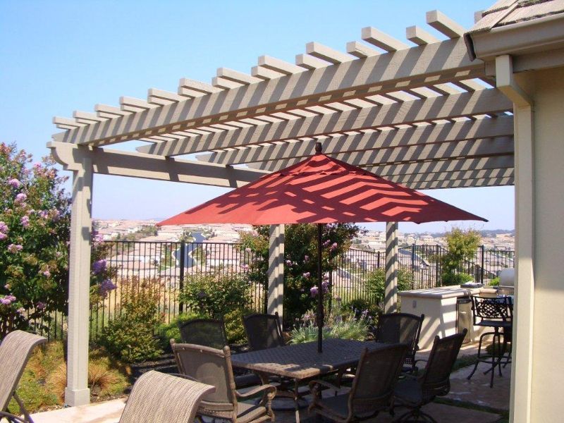 wooden pergola over backyard patio area