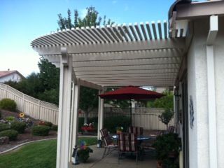 pergola painted white on the backyard porch area