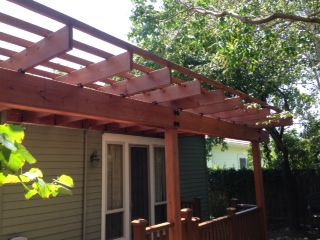 red colored wood pergola on back porch