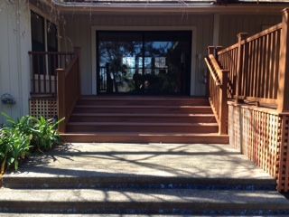 newly installed wood deck and steps with dark wood
