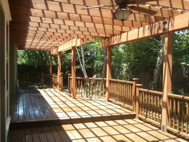unfinished wood pergola with matching deck railing