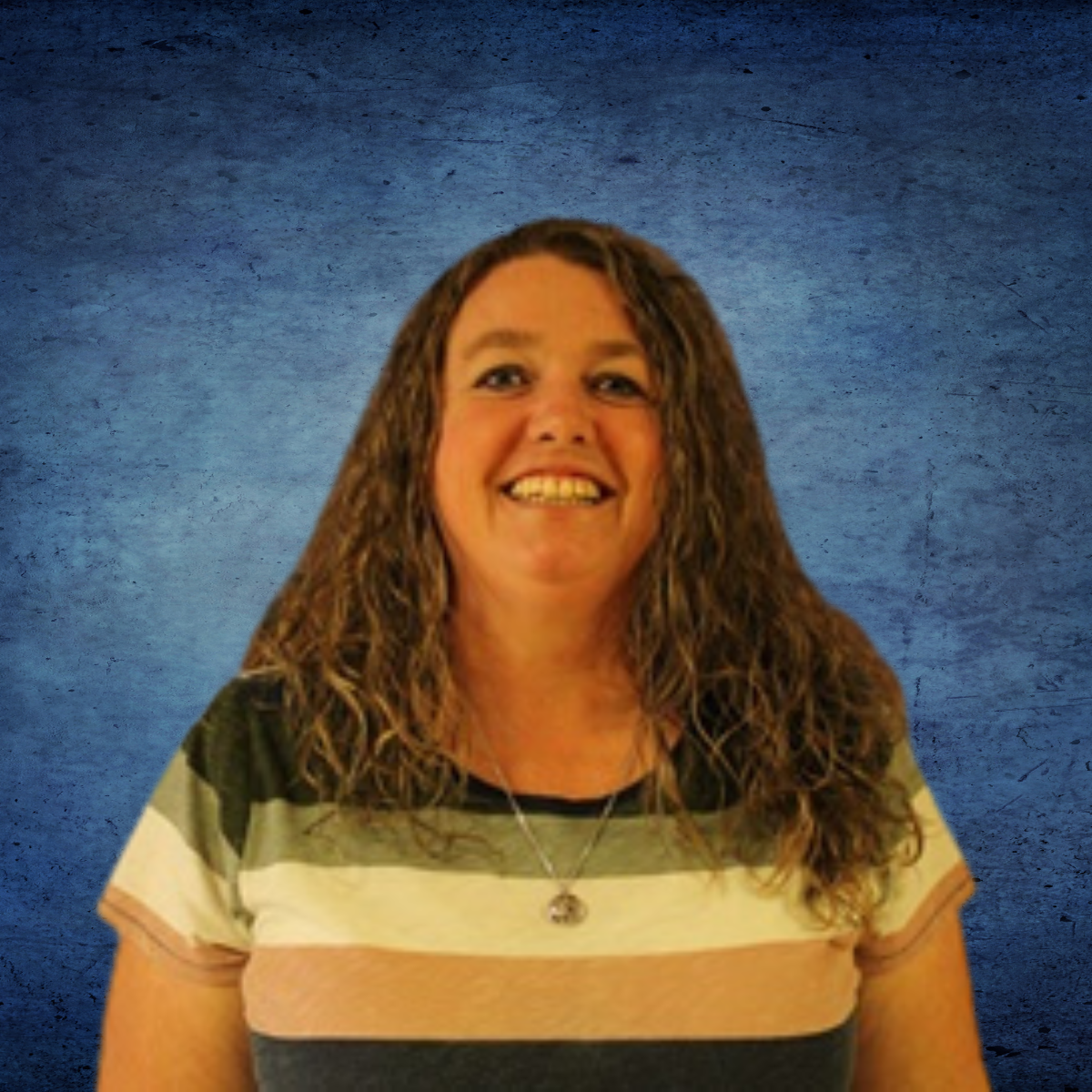 A woman in a striped shirt is smiling in front of a blue background