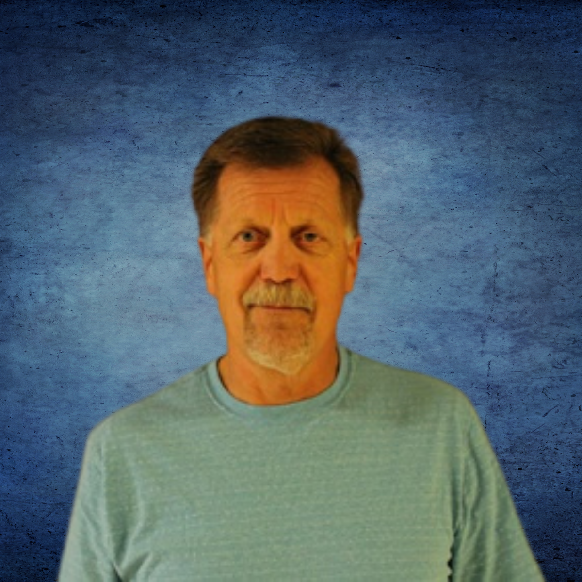 A man with a beard is wearing a blue shirt