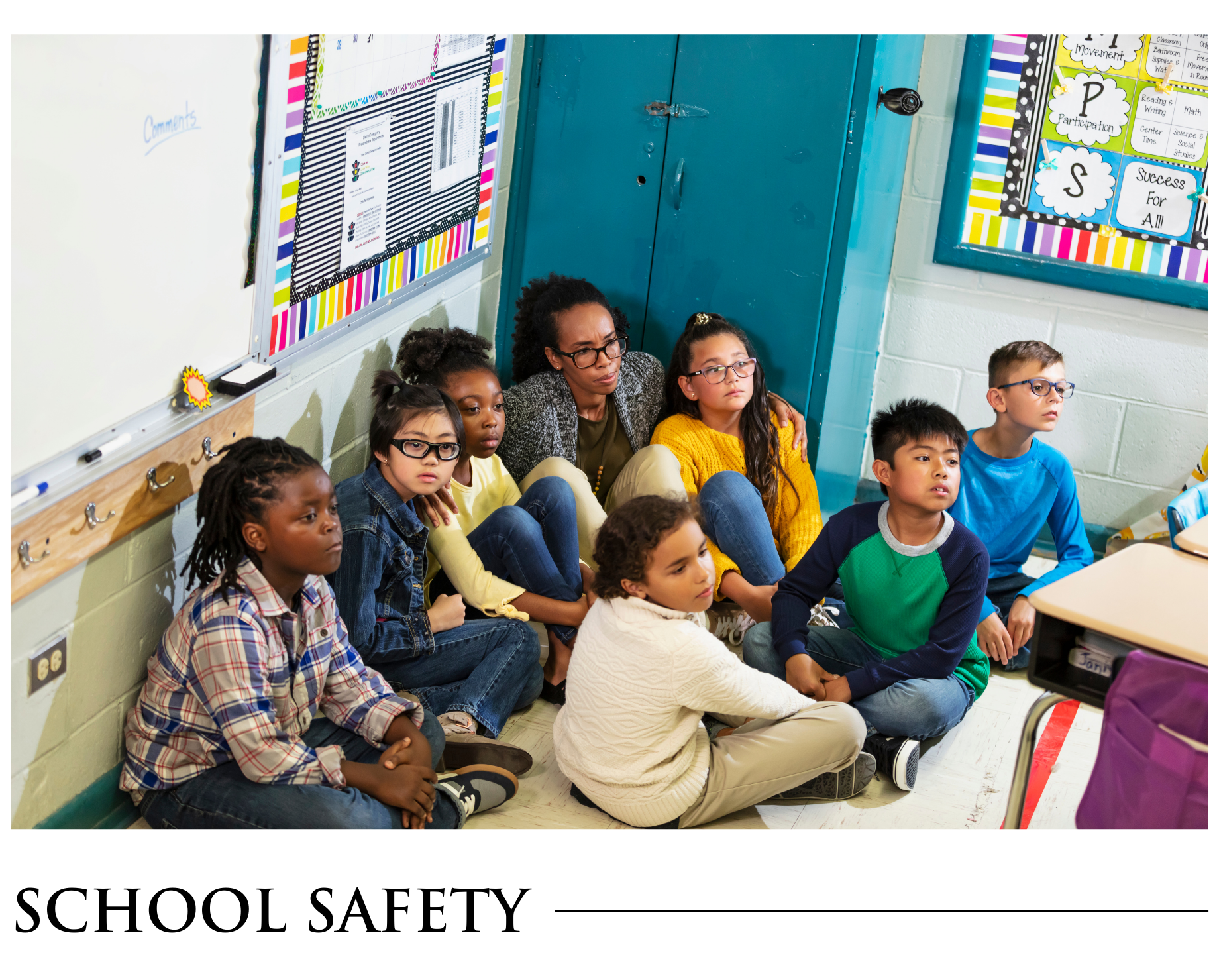 A group of children are sitting on the floor in a classroom.