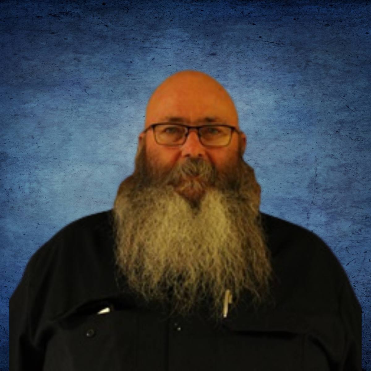 A bald man with glasses and a long beard