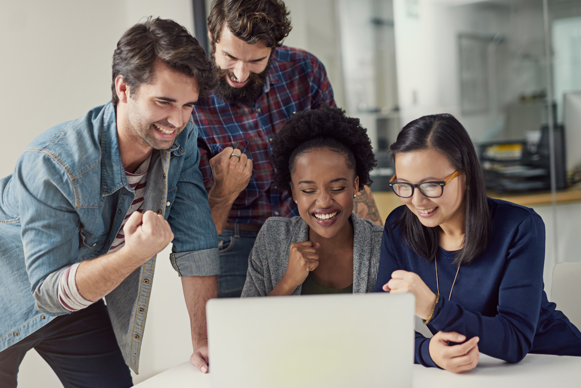 A group of people are looking at a laptop computer.