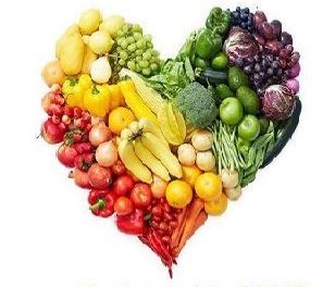 A heart made of fruits and vegetables on a white background.