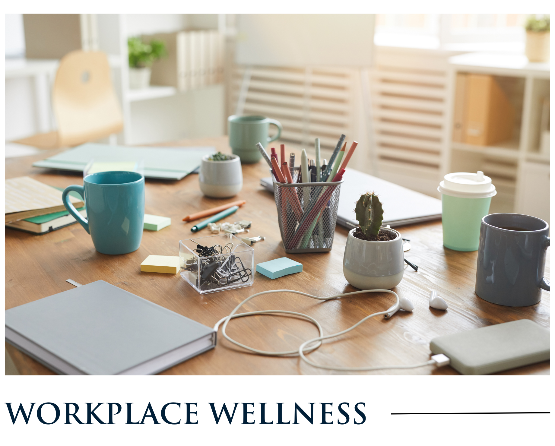 A wooden desk with a variety of office supplies on it.