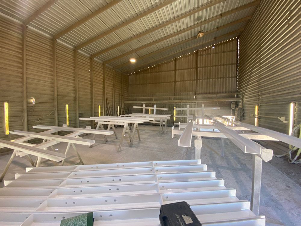 A Large Warehouse Filled With Lots Of Metal With White Coatings — Procoat QLD in Ryan, QLD