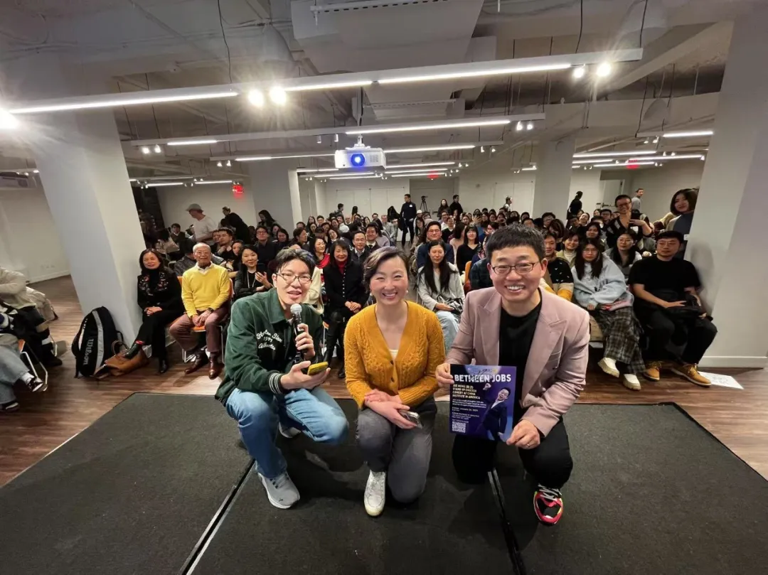 A group of people are posing for a picture in front of a crowd.