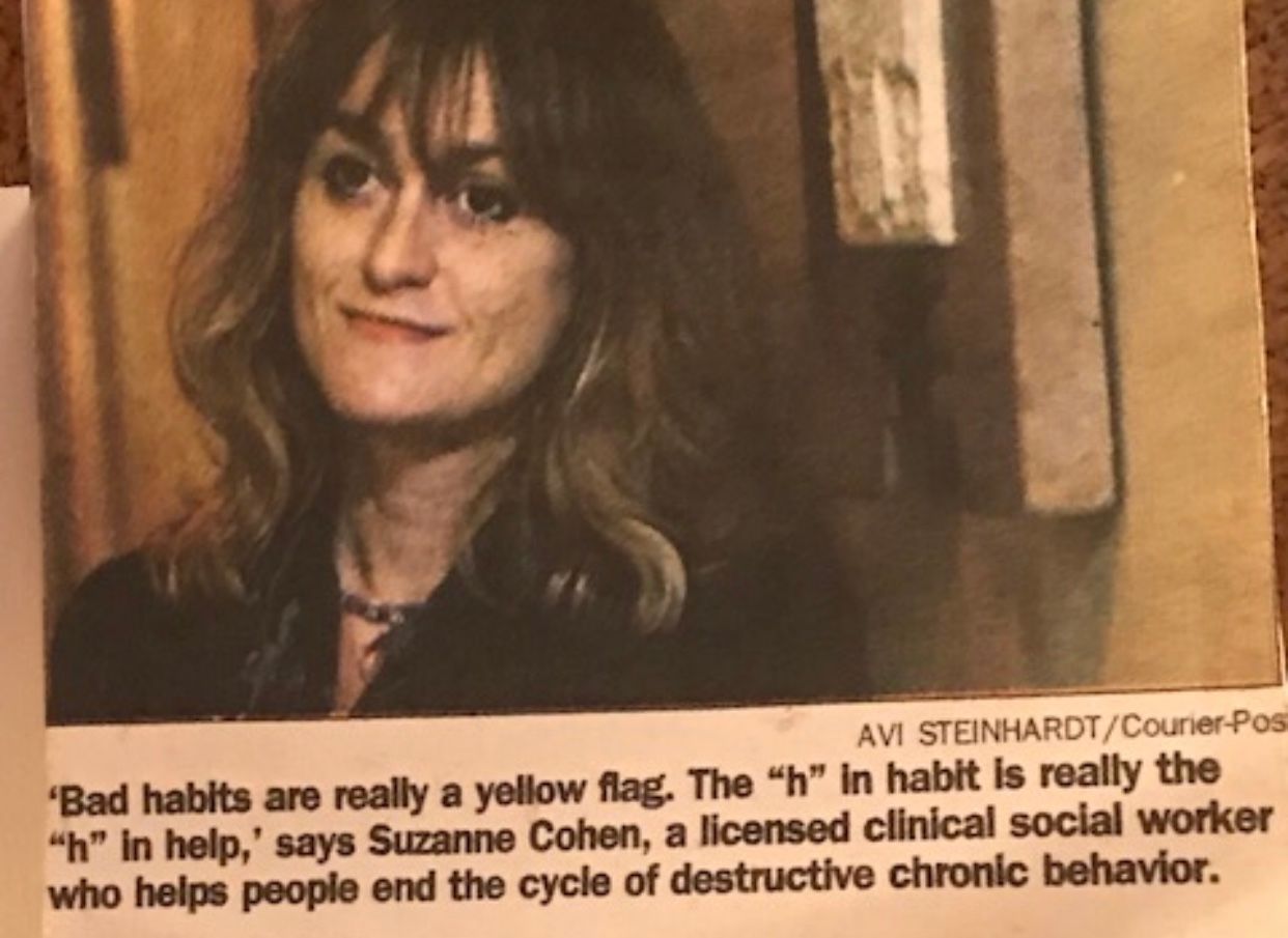 A woman with long blonde hair is smiling for the camera.