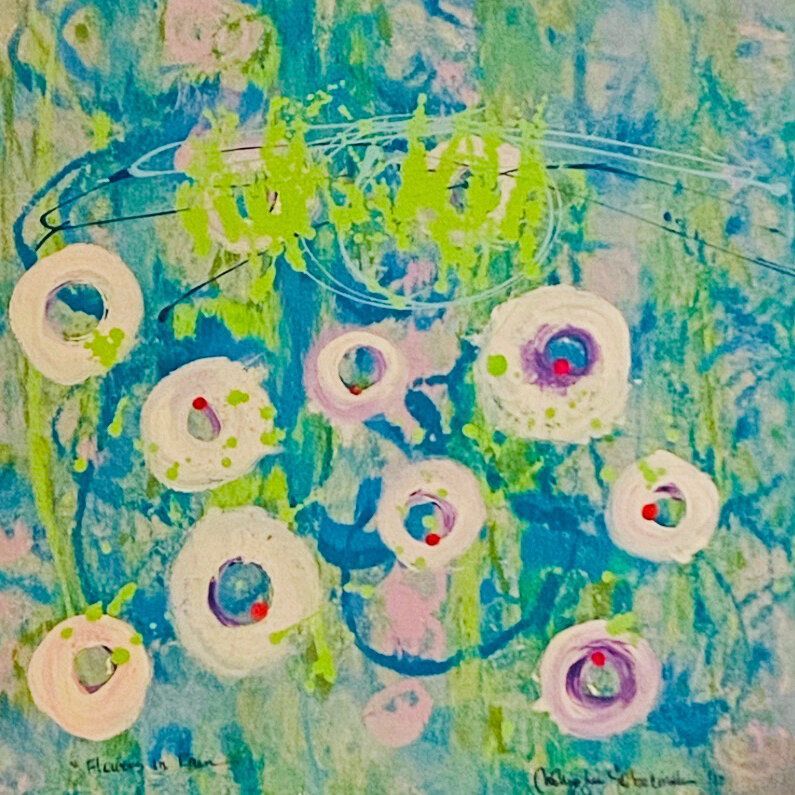 A painting of flowers on a blue and green background