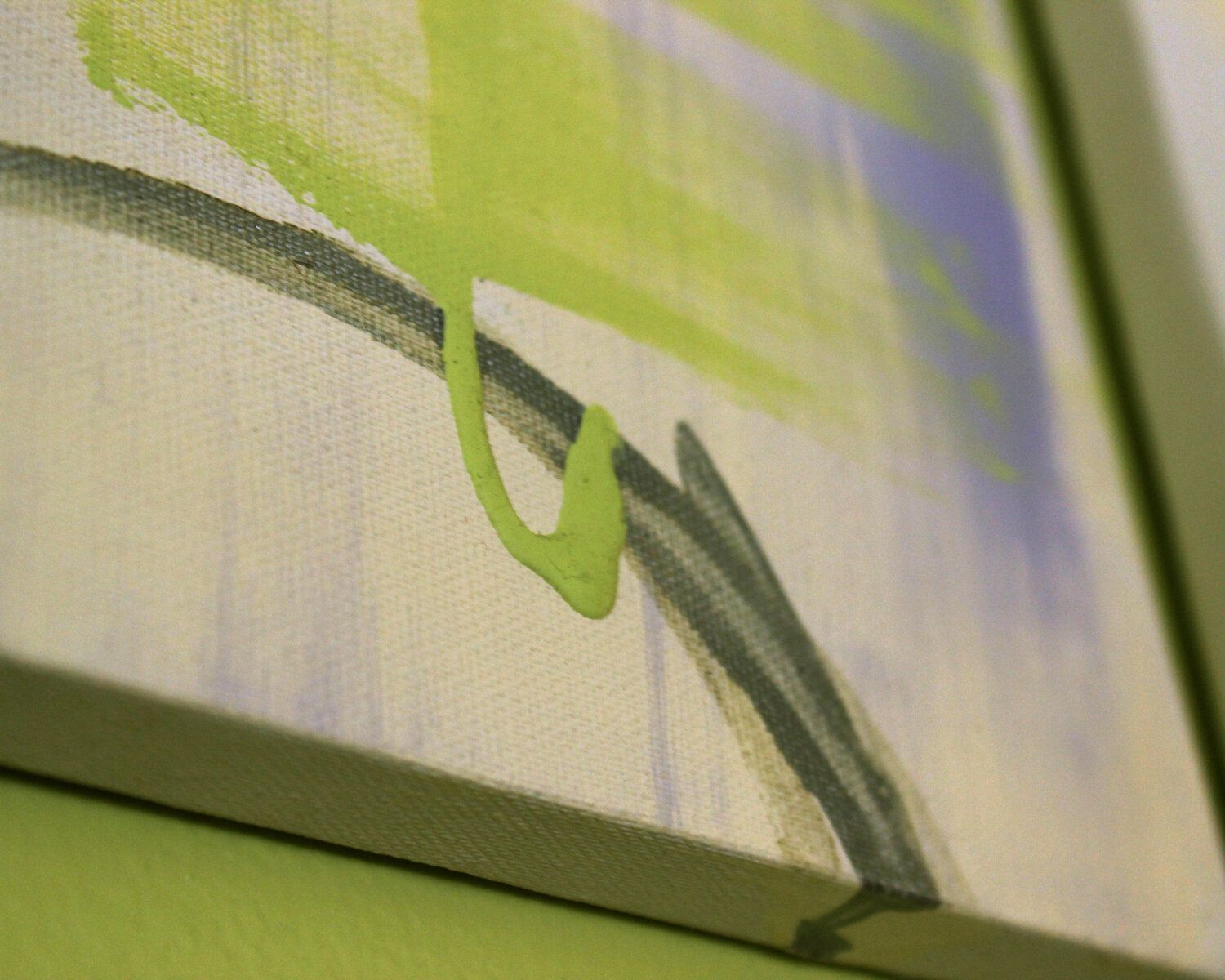 A close up of a painting on a green wall