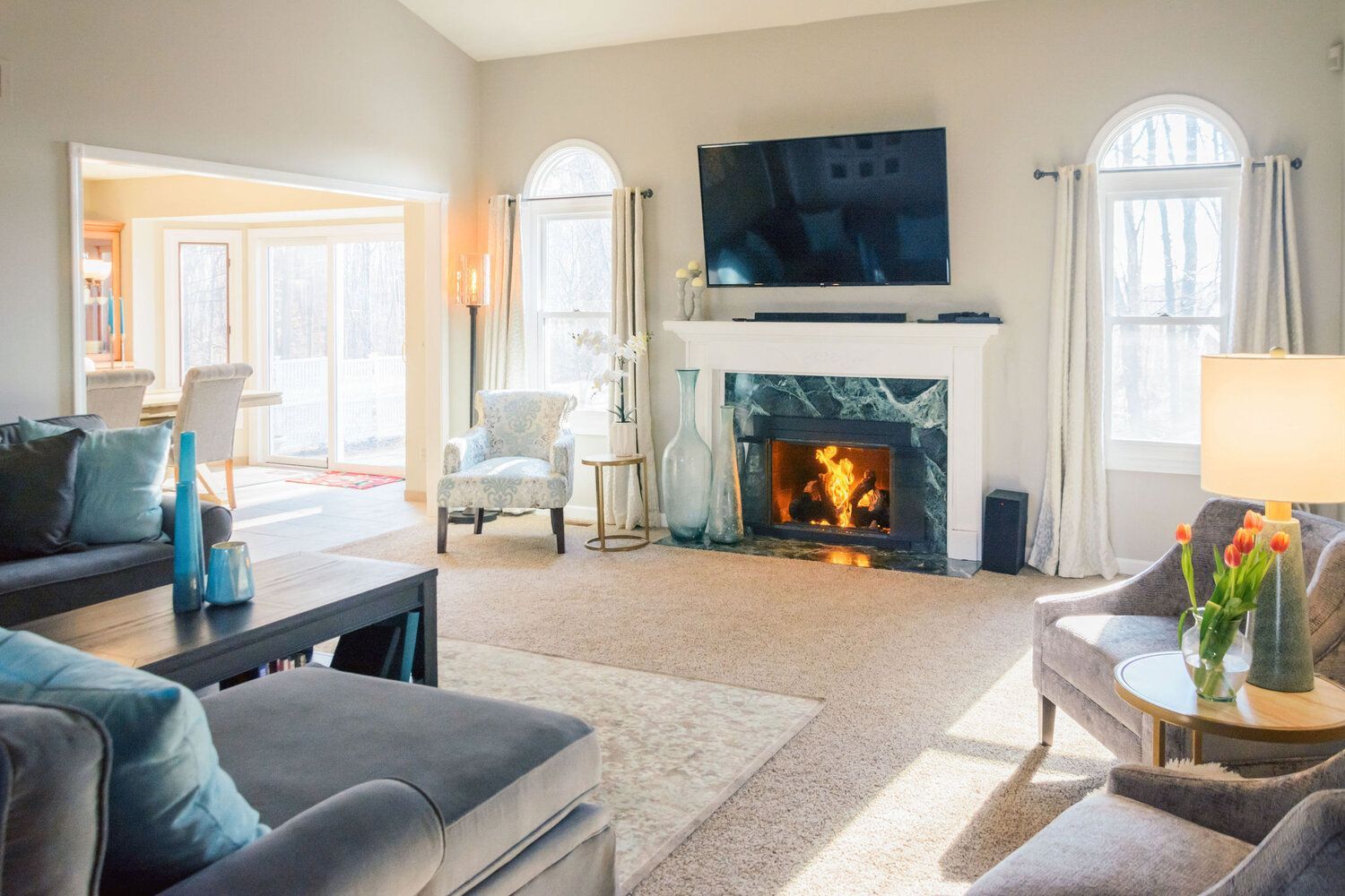 A living room filled with furniture and a fireplace.
