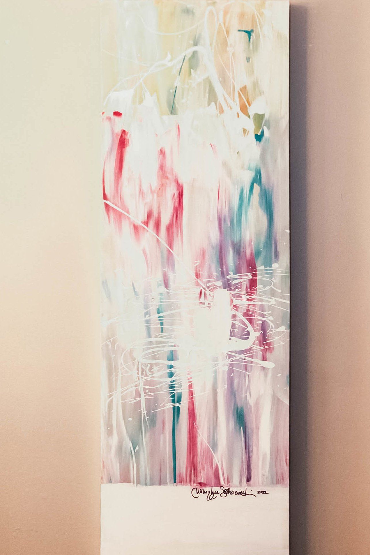 A colorful painting is hanging on a wall.