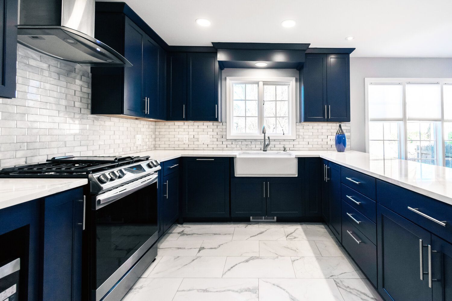 A stove top oven is sitting in a kitchen next to a brick wall.