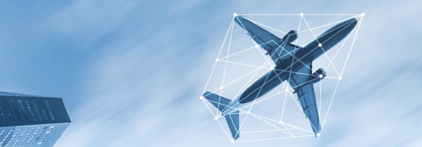 Person in safety vest near airplane on tarmac.