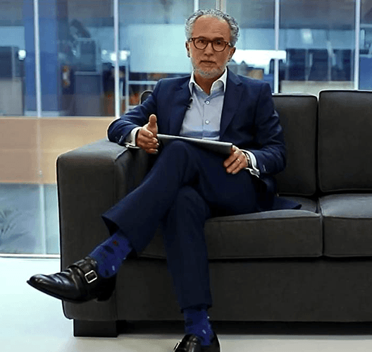 businessman sitting on a couch with tablet in his hands