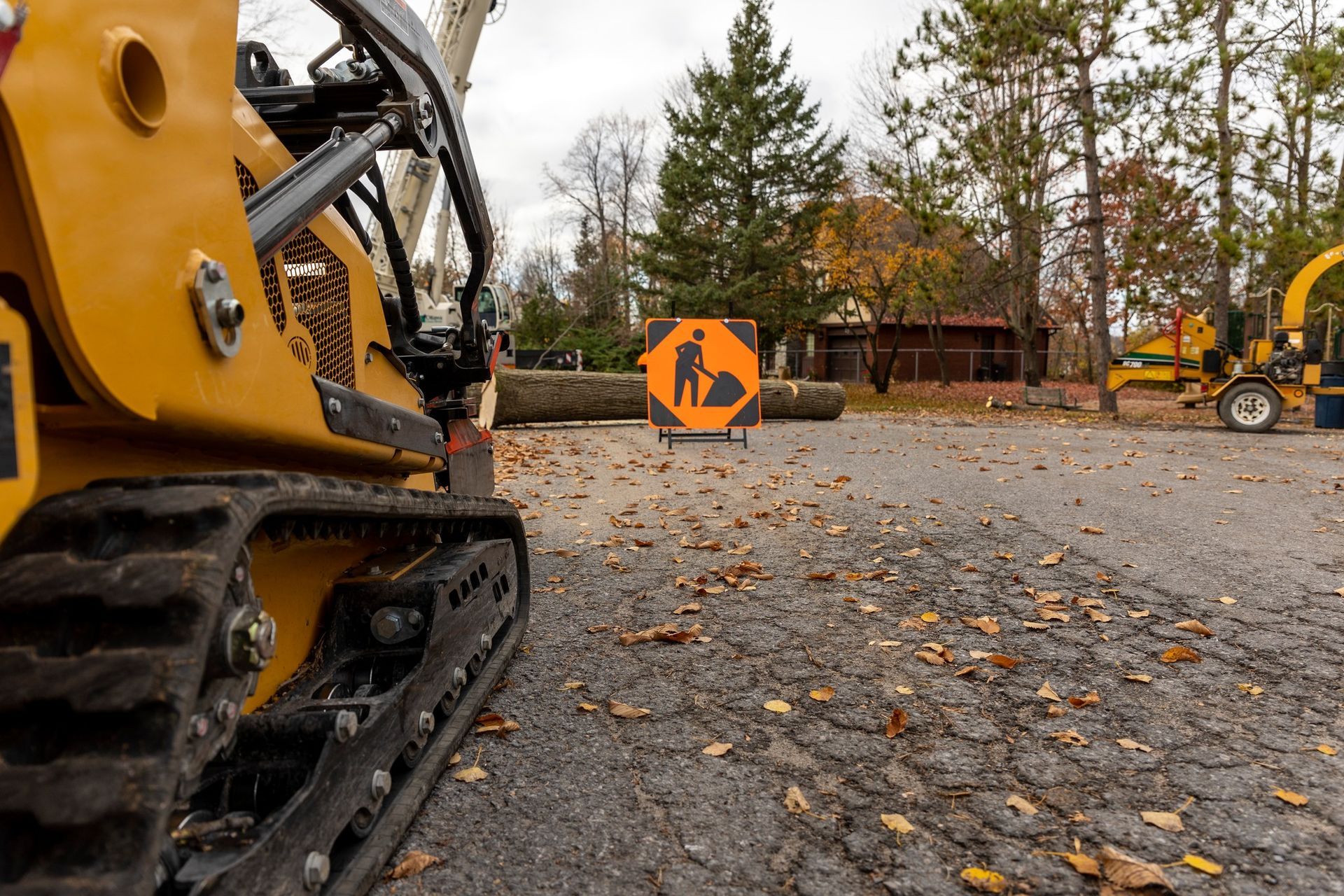 Yellow construction equipment on asphalt, orange 