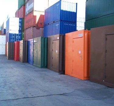 Colourful shipping containers in yard.
