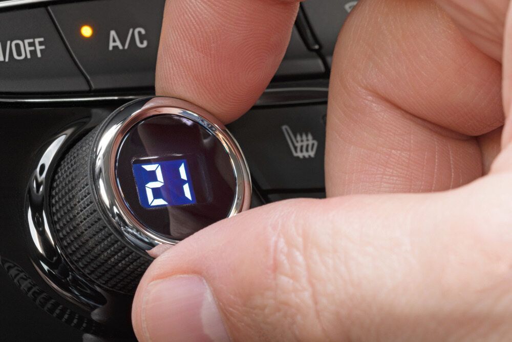 Hand Turning Car Climate Control Knob to Set Temperature to 21 Degrees Celsius — Direct Current Solutions in Mareeba, QLD