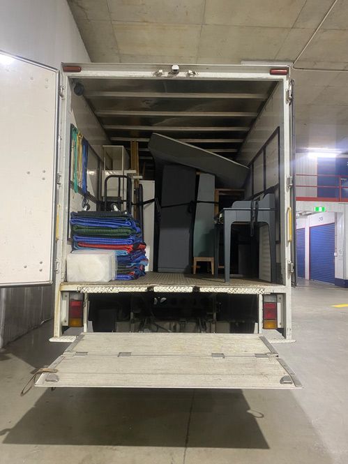 The Back Of A Moving Truck Is Filled With Furniture — Uplift Removals in Mackay, QLD