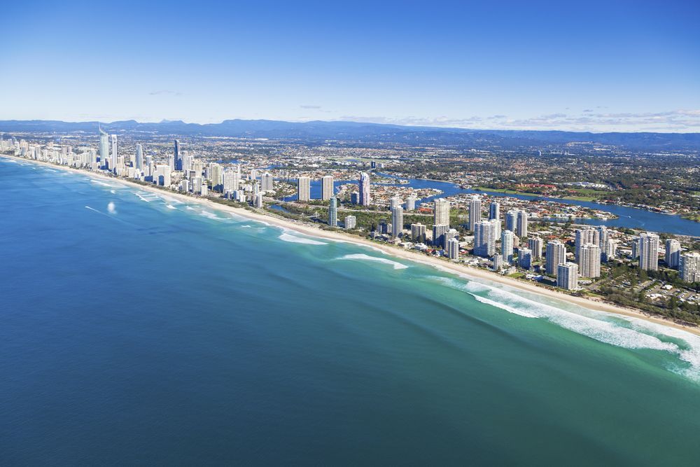 Coastal Cityscape With Tall Buildings Along a Sandy Beach and Blue Ocean — Uplift Removals in Gold Coast, QLD
