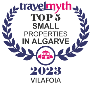 TravelMyth award: Top 5 Small Properties in Algarve, 2023. Features a laurel wreath, building icon, and 