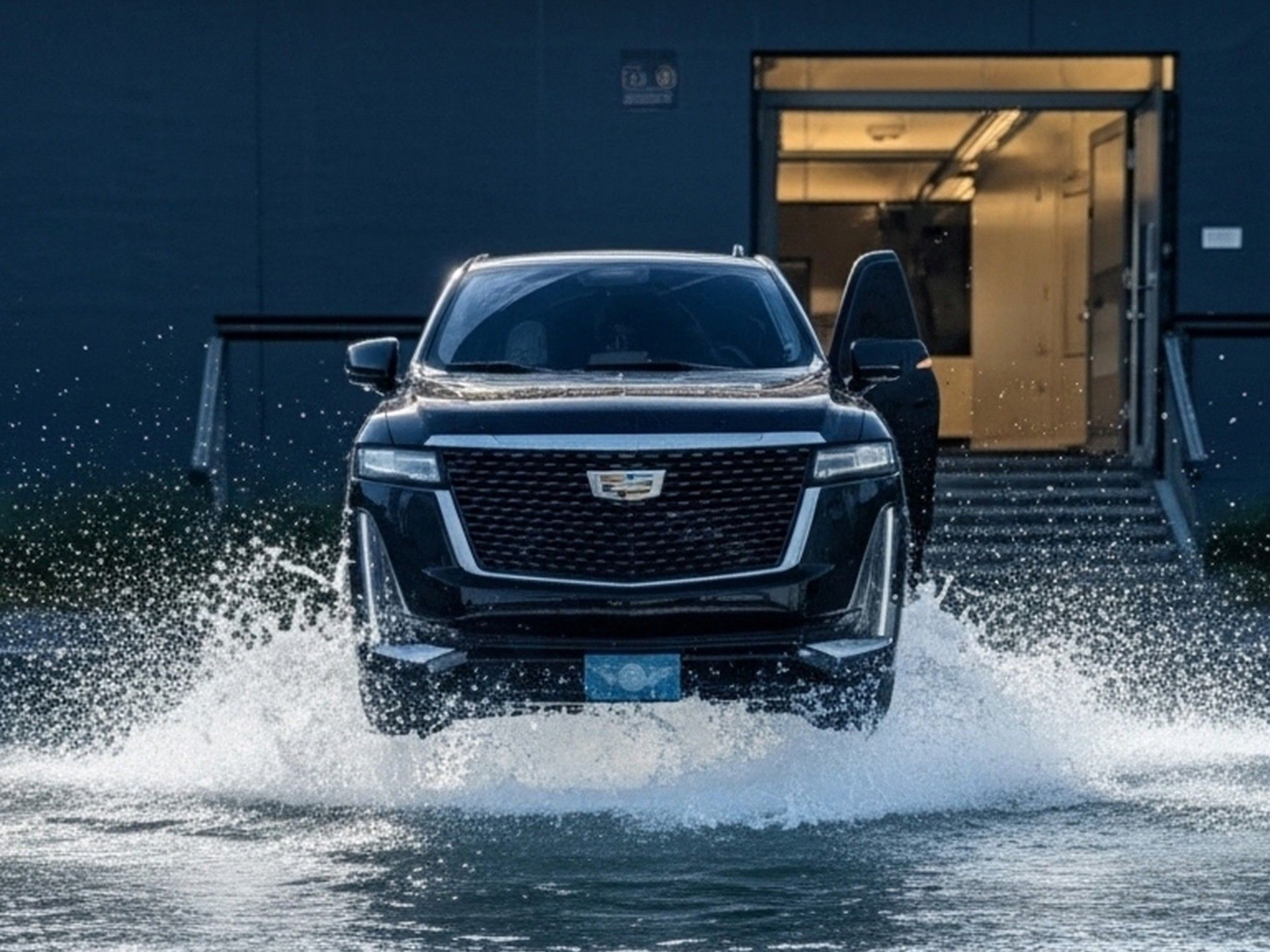 White Ford Transit van parked outside a store on a sunny day. A black pickup truck is in the background.