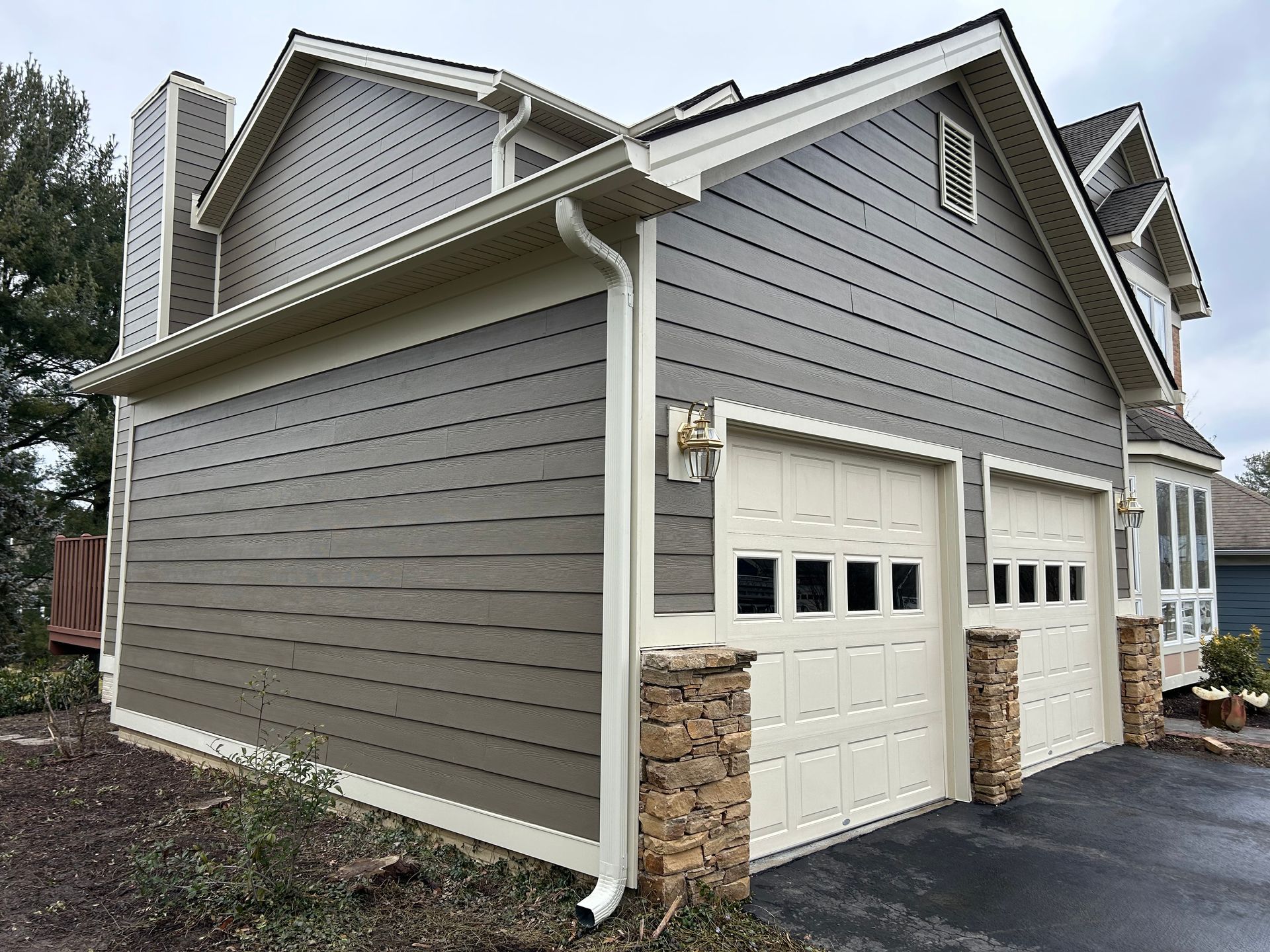 A house with two garage doors on the side of it