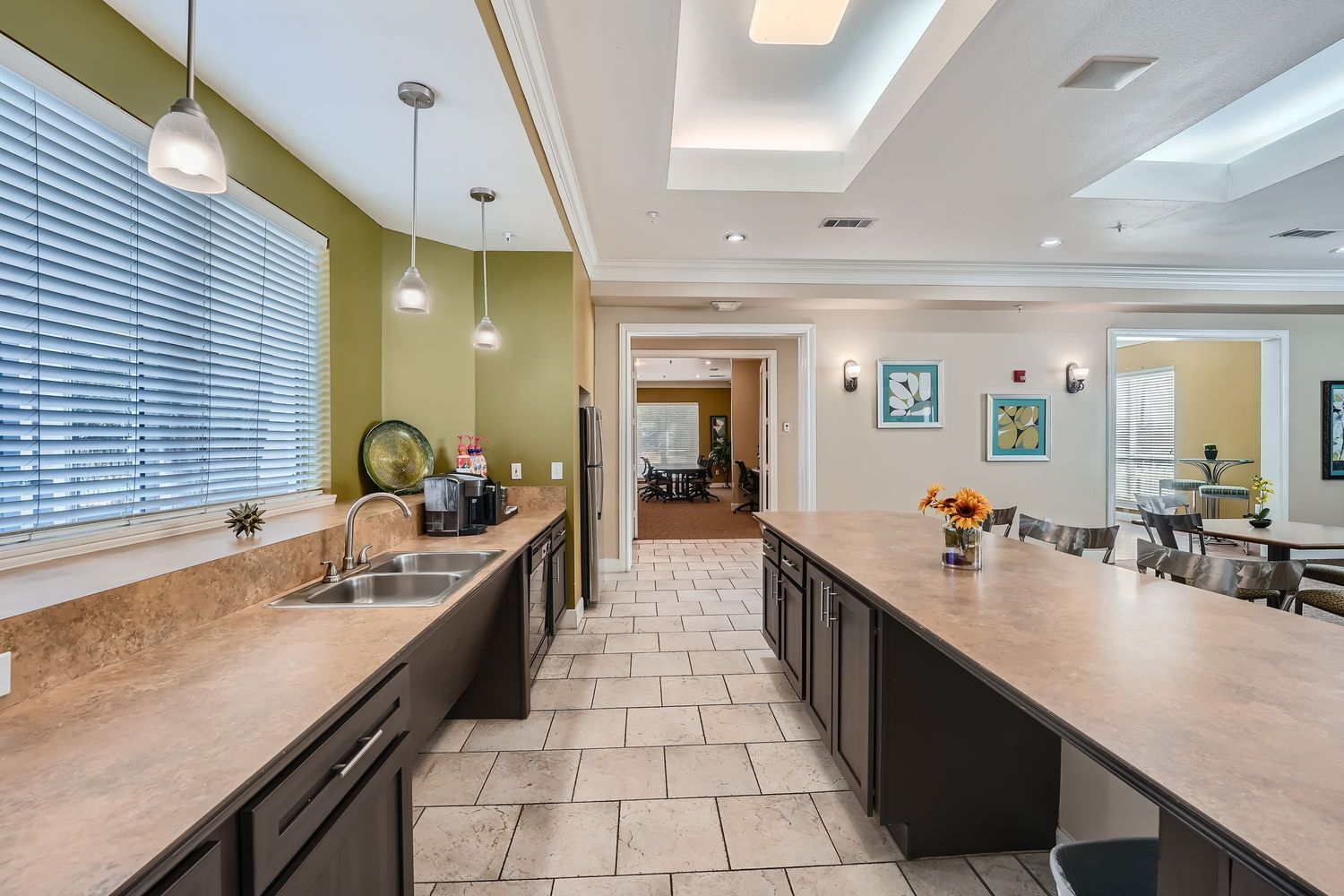 A kitchen with a long counter and a sink