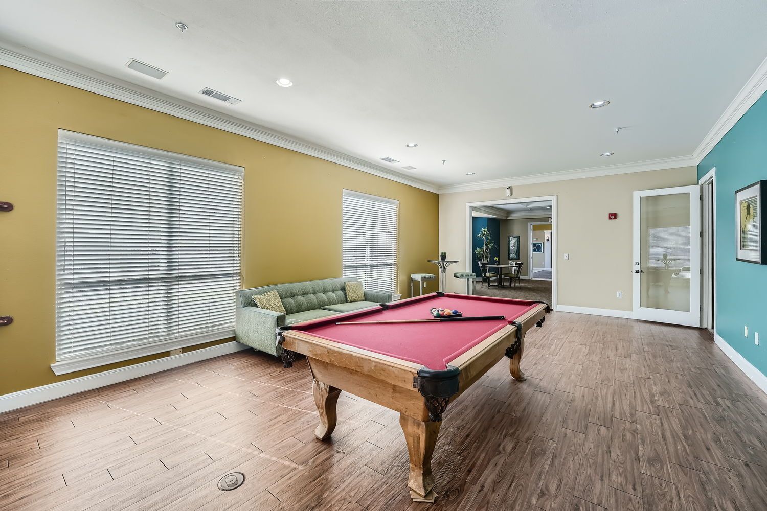 There is a pool table in the middle of the room.