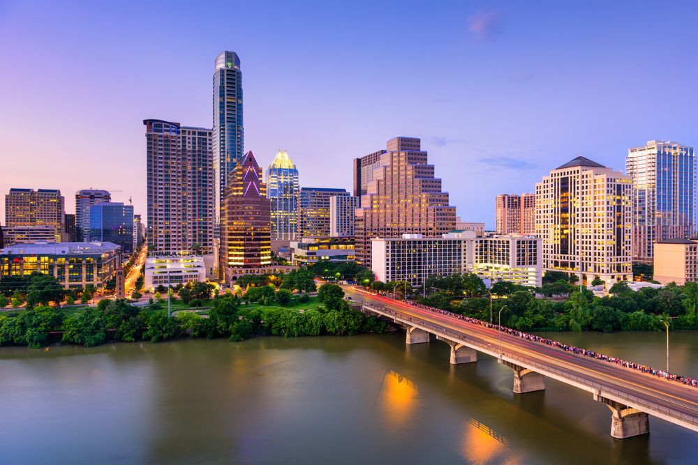 An aerial view of a city skyline with a bridge in the foreground.