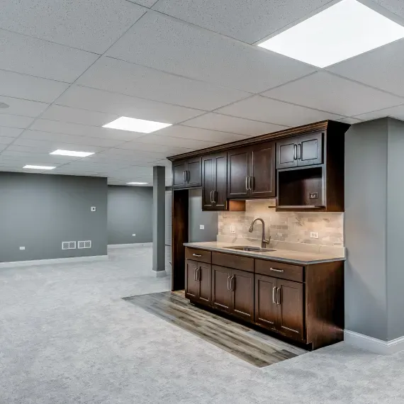 A kitchen with wooden cabinets and a sink
